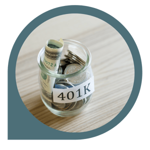 glass jar with 401k label on table with money inside